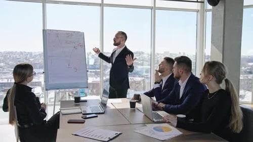 Group of business people having meeting in office with big windows.