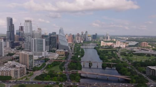 Aerial View of Colorado River in Downtown Austin Showcasing Its Modern Skyscrapers Green Landscapes