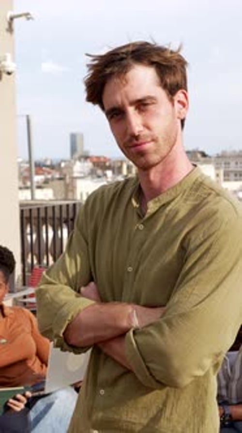 Confident Young Businessman Posing on a Rooftop Terrace
