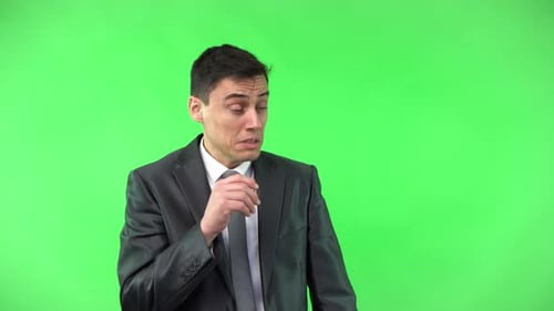 Man in Suit Coughing Against Green Screen
