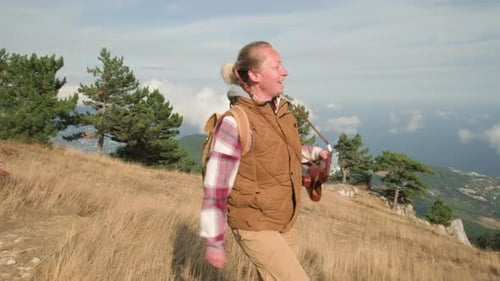 Woman Hiker with Vintage Camera on Scenic Mountain