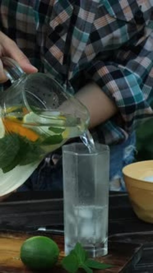 Pouring Refreshing Iced Beverage in Glass