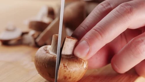 Chef Cutting the Mushrooms on a Wooden Board with Knife Mushroom Cooking Close Up