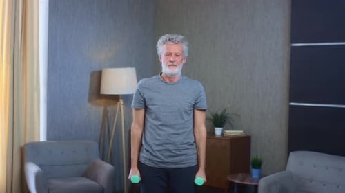 Senior Man Exercising with Dumbbells at Home