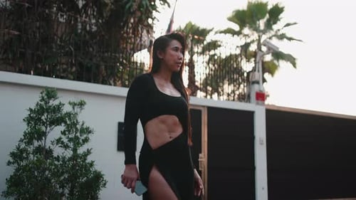 Attractive woman poses confidently in modern black outfit