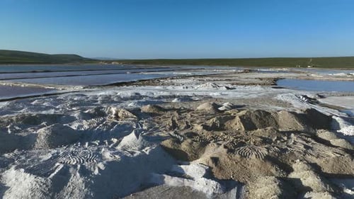 Flyover mounds of dirty salt extracted from sea water in salt pan ponds
