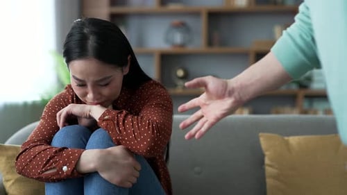 Woman Cries on Couch as Man Threatens