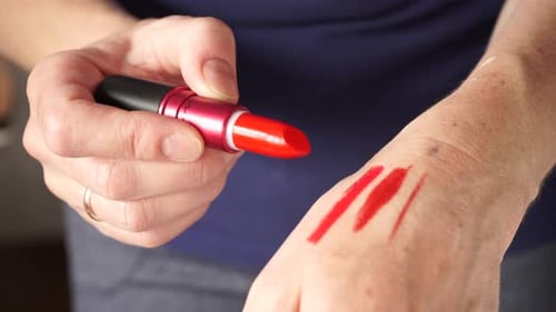 Verschiedene Lippenstiftfarben auf der Hand ausprobieren