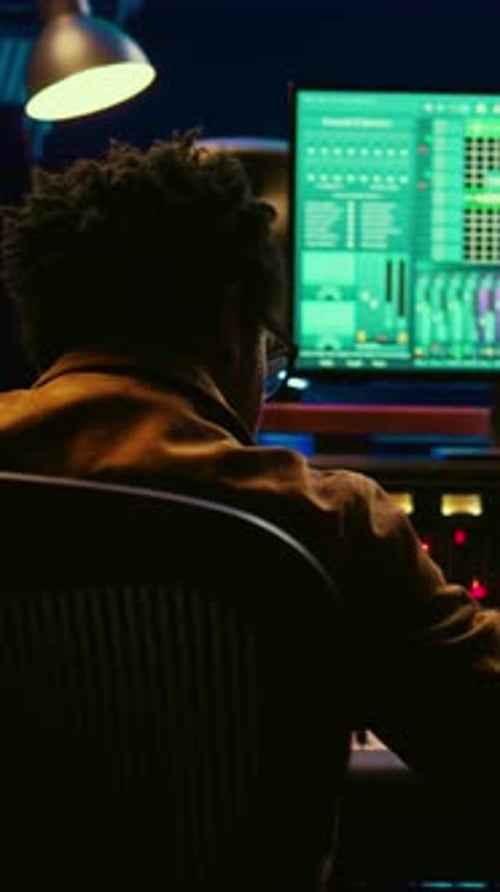 Vertical Video African American Audio Engineer Using Sound Mixing Console for Managing Tracks
