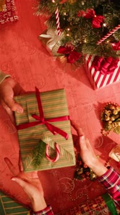 Friends Giving Presents to Each Other Top View Celebrating New Year Sitting at Dining Table