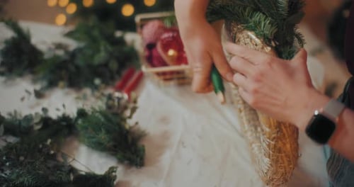Woman Making a Christmas Wreath Close Up