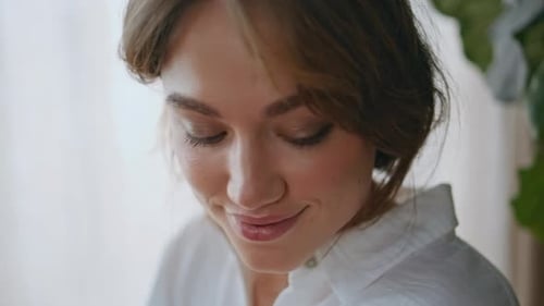 Young Woman Smiling Indoors, Close Up