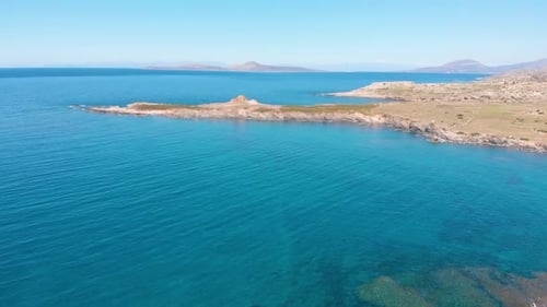 Aerial beautiful beach and water bay in the greek spectacular coast line. Turquoise blue transparent