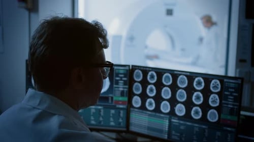 In Medical Laboratory Patient Undergoes MRI or CT Scan Process under Supervision of Radiologist, in