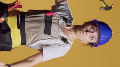 Vertical Video Portrait of Aggressive Constructor Threating with Hammer