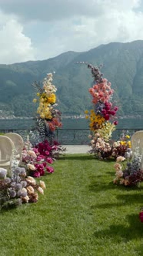 A Stunning Outdoor Wedding Setup with Beautiful Floral Arrangements and a Romantic View Action