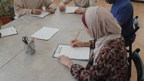 Muslimische Frau arbeitet an einem Grammatiktest