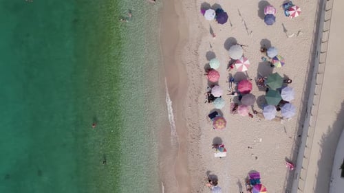 Top down aerial over white sand beach and crystal clear water, Himarë, Albania