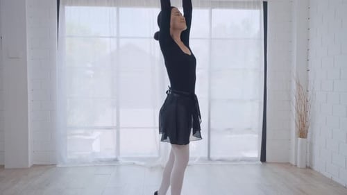 Graceful Woman Practicing Ballet in a Bright Studio