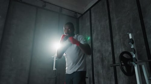 Man Boxing Training Punches in Gym African American Sportive Focused Boxer Fighter Practicing Hits