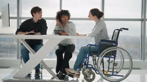 Young Business Woman Sitting Wheelchair While Work Young Business People Working in Office Workplace