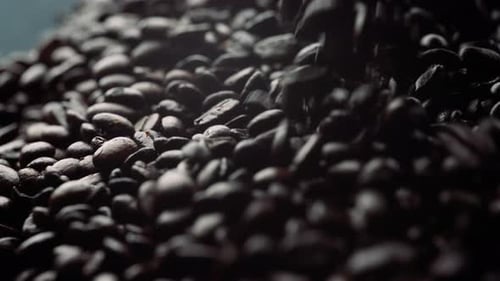 Roasted coffee beans falling in slow motion