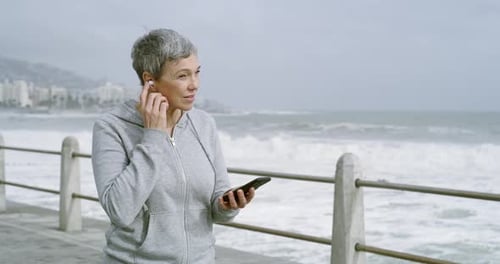 Music, earphones or senior woman running by beach for fitness, sports or cardio