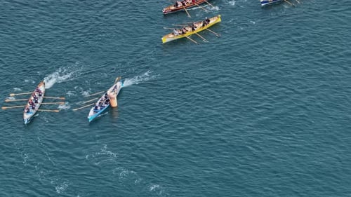 Aerial telephoto shot of rowing boats turning around a buoy during a regatta