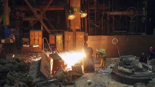 A Bustling Industrial Foundry Scene Featuring the Pouring of Molten Metal in Action Stock Clip
