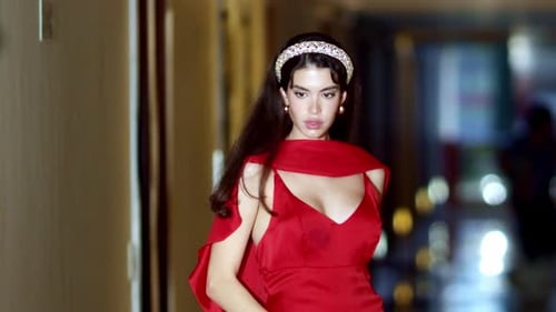 Elegant Woman Posing in Red Dress in Urban Setting