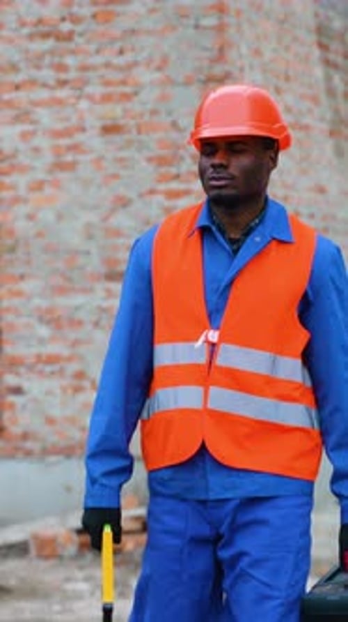 African American Builder Inspecting Residential Building Site