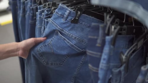 Woman is choosing jeans at a mass market store
