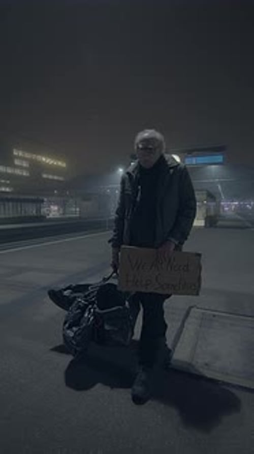 In a Dark and Lonely Nighttime Environment an Elderly Man Desperately Seeks Help and Support