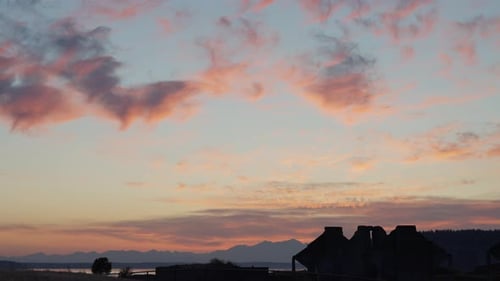 Sunset with pink clouds and structure silhouette
