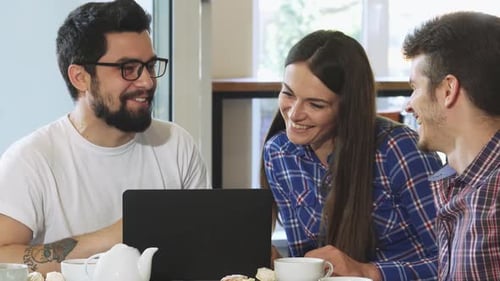 Charming Bearded Man Enjoying Breakfast with Friends at a Cozy Coffee Shop
