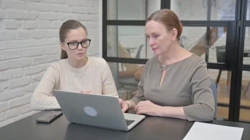 Business People Discussing Project while Sitting in Office
