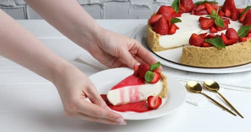 Strawberry cheesecake decorated with fresh strawberries and mint