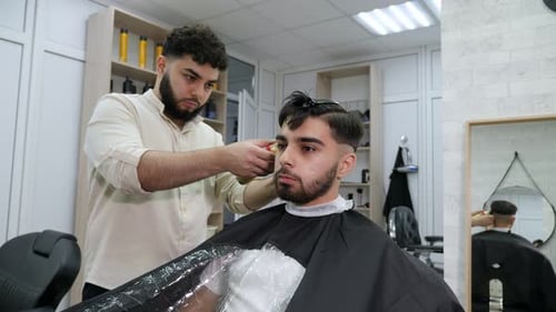 Man Getting a Haircut in Barber Shop