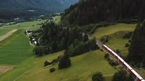 Drone Follows Famous Red Glacier Express Train Moving Along Epic Summer Switzerland Alps Adventure