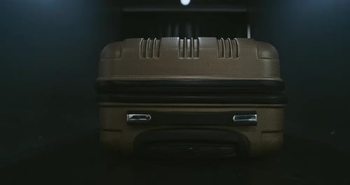 Suitcase on Baggage Carousel in a Dark Room