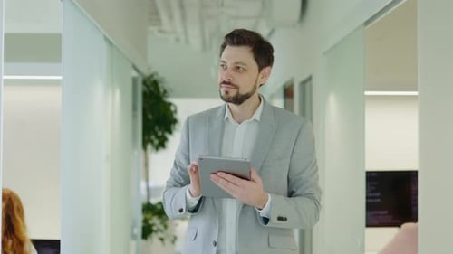 Businessman Walking in the Office Using Digital Tablet Texting with Clients Successful Boss Manager