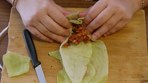 Woman Preparing Stuffed Cabbage Rolls at Home