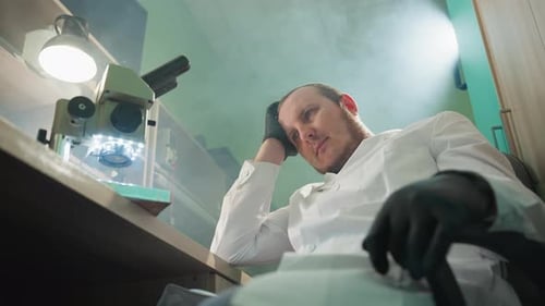 Scientist Resting at a Desk in a Lab