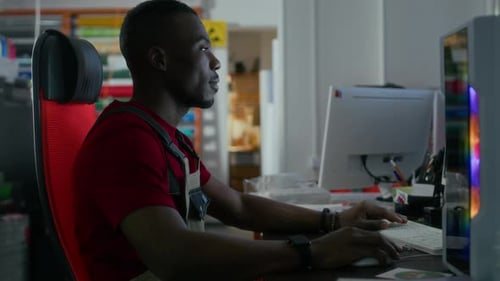 Worker Working On Computer In Workshop