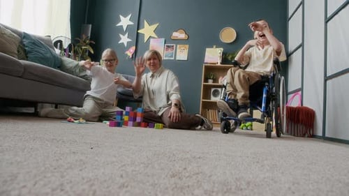Smiling Children and Woman Building Blocks at Home