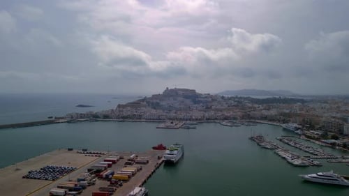Historic old town with castle on mountain, large harbor with ships and yachts.
Amazing aerial view f