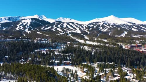 Beautiful Snow Covered Winter Mountain Peaks Aerial Drone View with Ski Trails Ready for Outdoor Spo