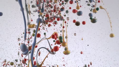 Colorful paint droplets and strands falling in clear liquid