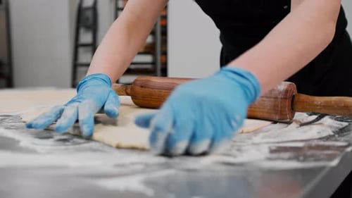 Person Rolling Dough with Rolling Pin