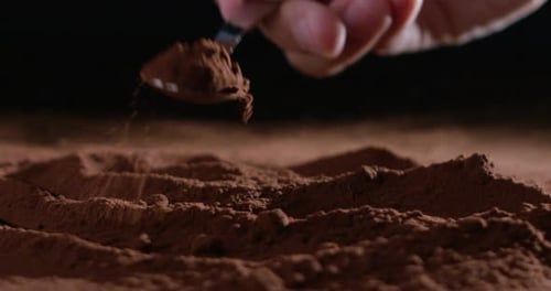 Cocoa Powder Stirred and Scattered with Spoon